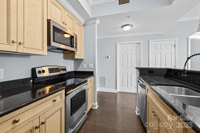 a kitchen with stainless steel appliances granite countertop a stove and a microwave