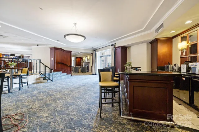a living room with furniture a table and kitchen chandelier