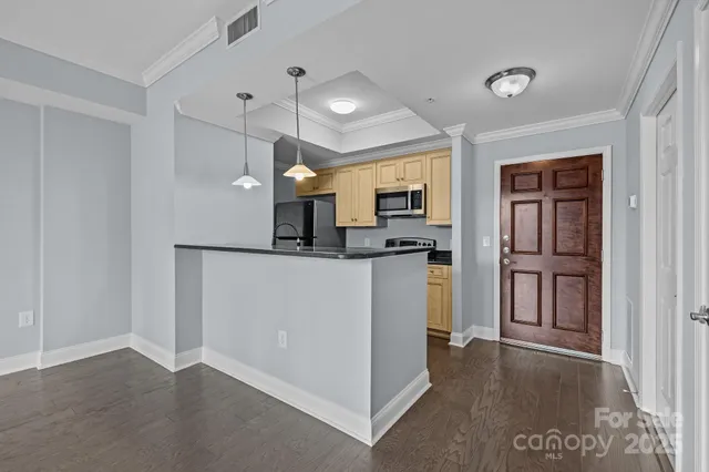 a view of kitchen with refrigerator and window