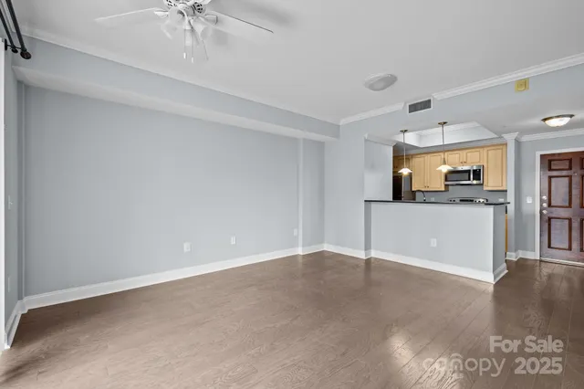 a view of a kitchen with a sink and a refrigerator