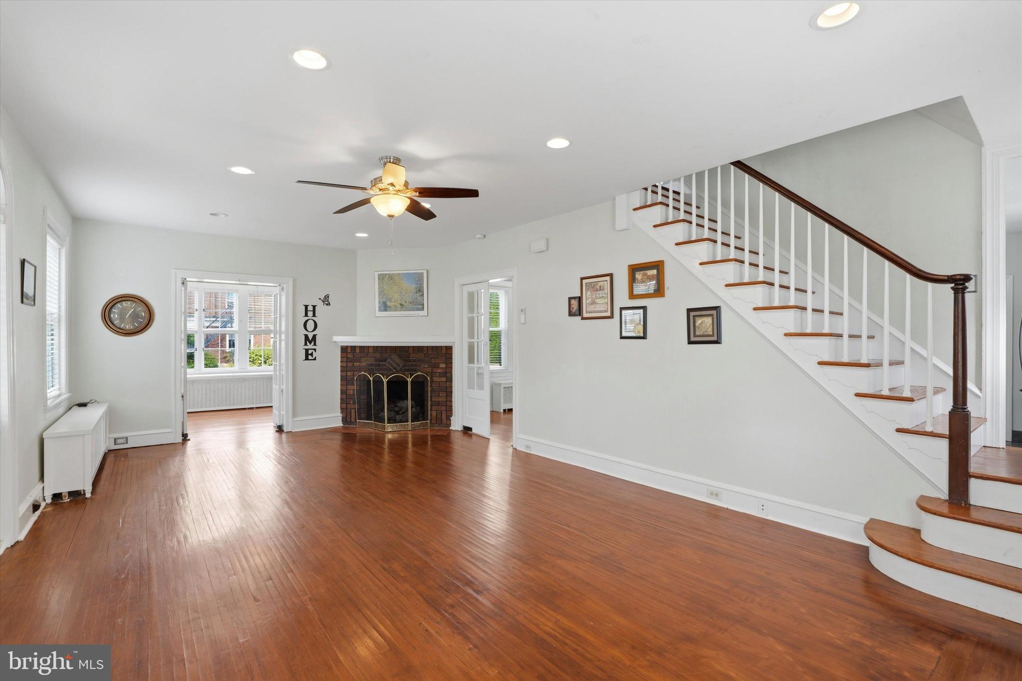 401 West Lancaster Avenue Shillington, PA 19607 - Photo 6 of 47 a view of a livingroom with furniture a fireplace wooden floor and chandelier