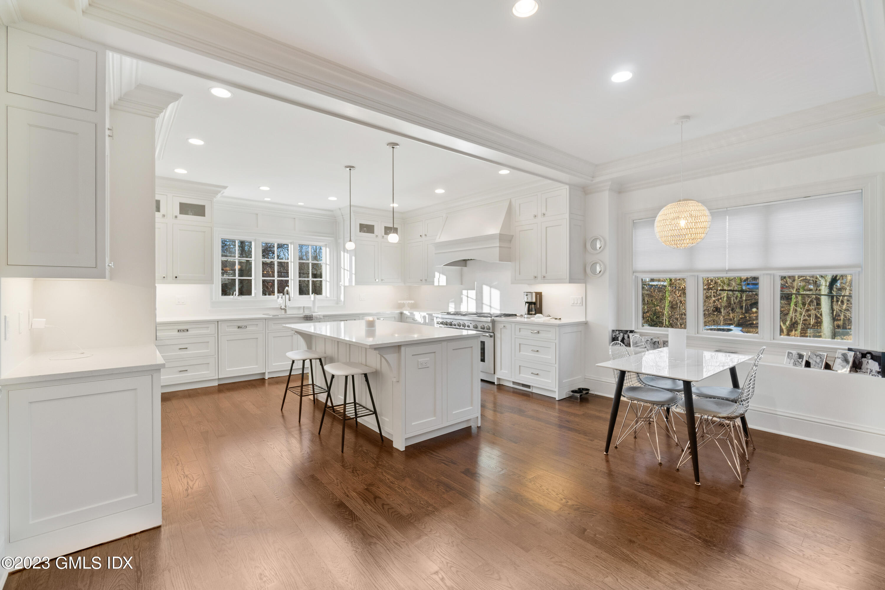 3 Orchard Place, Unit A Greenwich, CT 06830 - Photo 7 of 24 a kitchen with a table chairs wooden floors and a view of living room