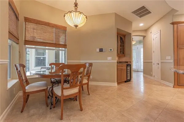 a view of a dining room with furniture large window and chandelier
