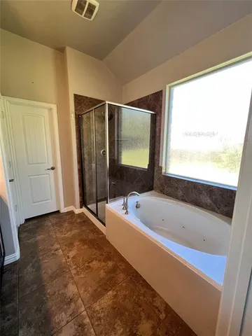 a bathroom with a bathtub and a shower