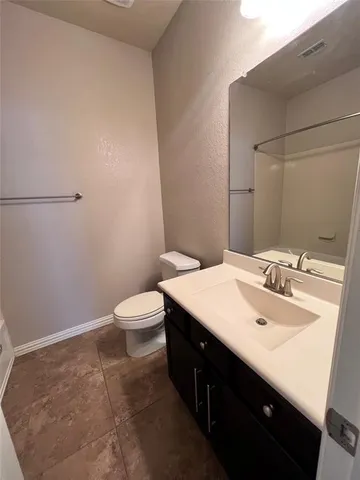 a bathroom with a sink a toilet and mirror