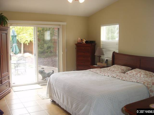 605 Sugar Tree Court Reno, NV 89511 - Photo 3 of 9 a bedroom with a bed and a large window
