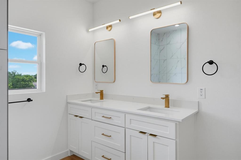 508 South O Connor Road Irving, TX 75060 - Photo 15 of 21 Double vanity with white cabinetry and gold-tone hardware