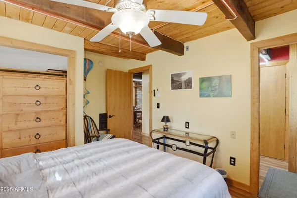 a bedroom with a bed and a chandelier