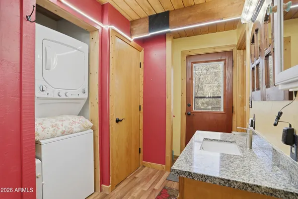 a en suite bathroom with a granite countertop sink and a mirror