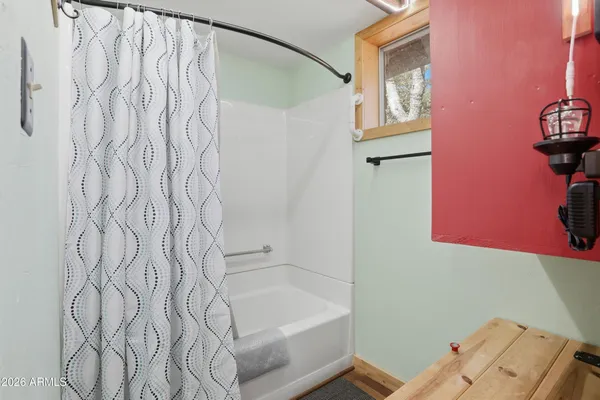 a bathroom with a bathtub and shower