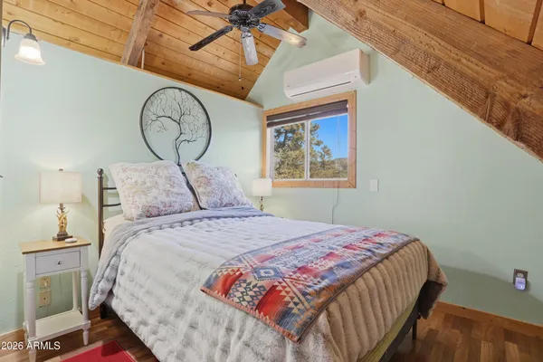 a bed sitting in a bedroom next to a window