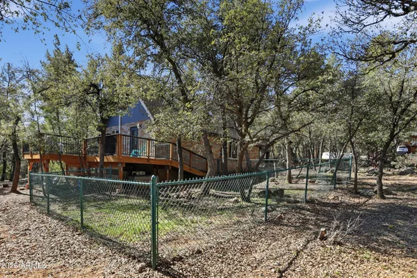 a view of house with a backyard