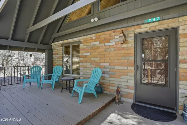 a view of a deck with table and chairs and wooden floor