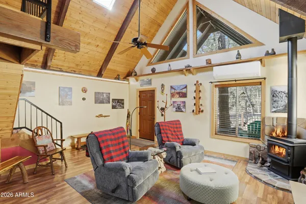 a living room with furniture a flat screen tv and a window