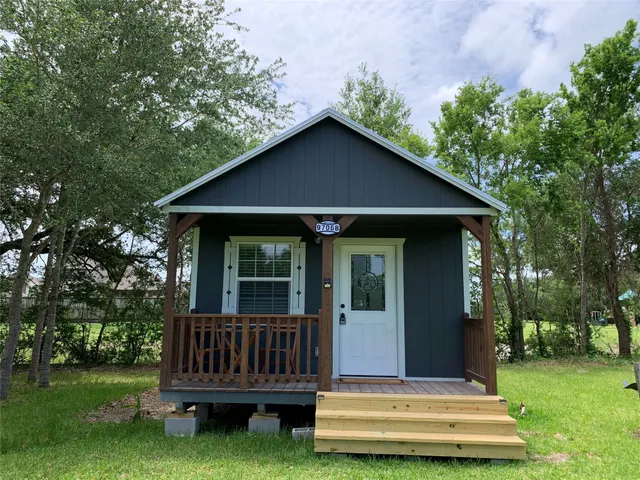 a view of a house with a yard deck and a garden