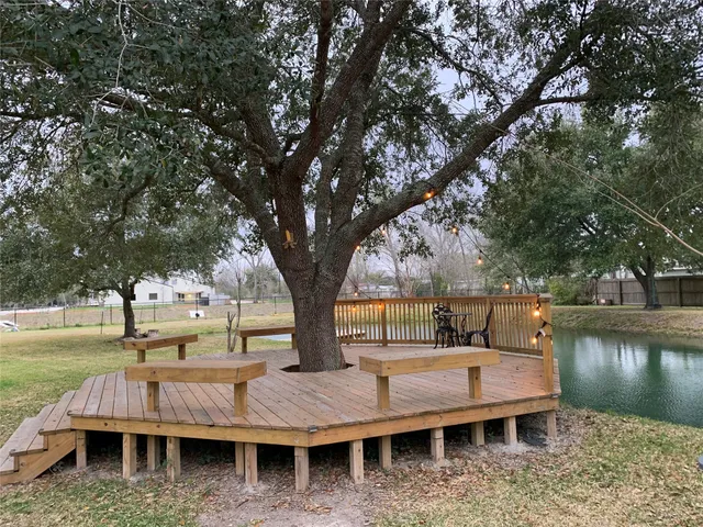 a view of swimming pool with outdoor seating and lake