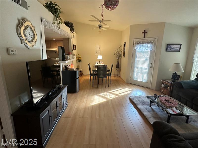 1830 North Pecos Road, Unit 230 Las Vegas, NV 89115 - Photo 4 of 16 An inviting open-concept area combines living and dining, accented by light wood flooring and high ceilings.
