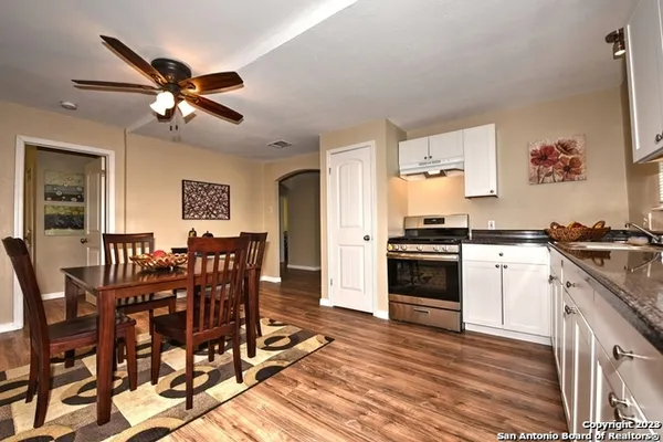 a view of a dining room with furniture and a kitchen