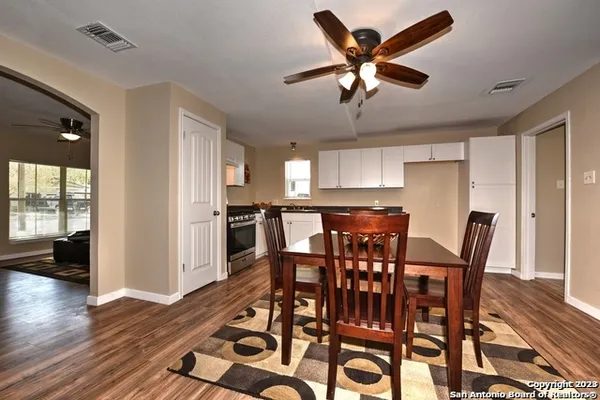 a view of a dining room with furniture and wooden floor