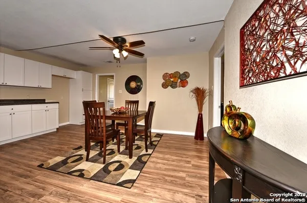 a view of a dining room with furniture and chandelier