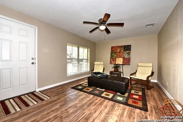 a living room with a bed furniture and a window