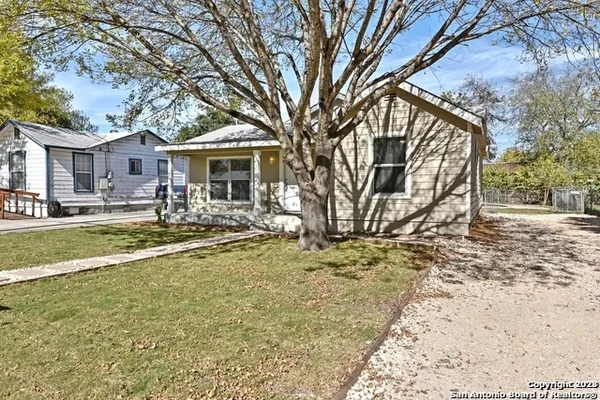 a view of a house with a yard covered in snow