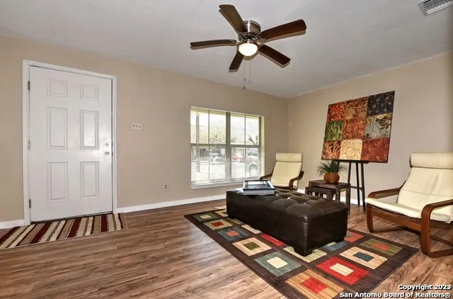 a living room with furniture rug and window