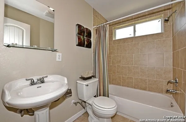 a bathroom with a sink a toilet and a bathtub