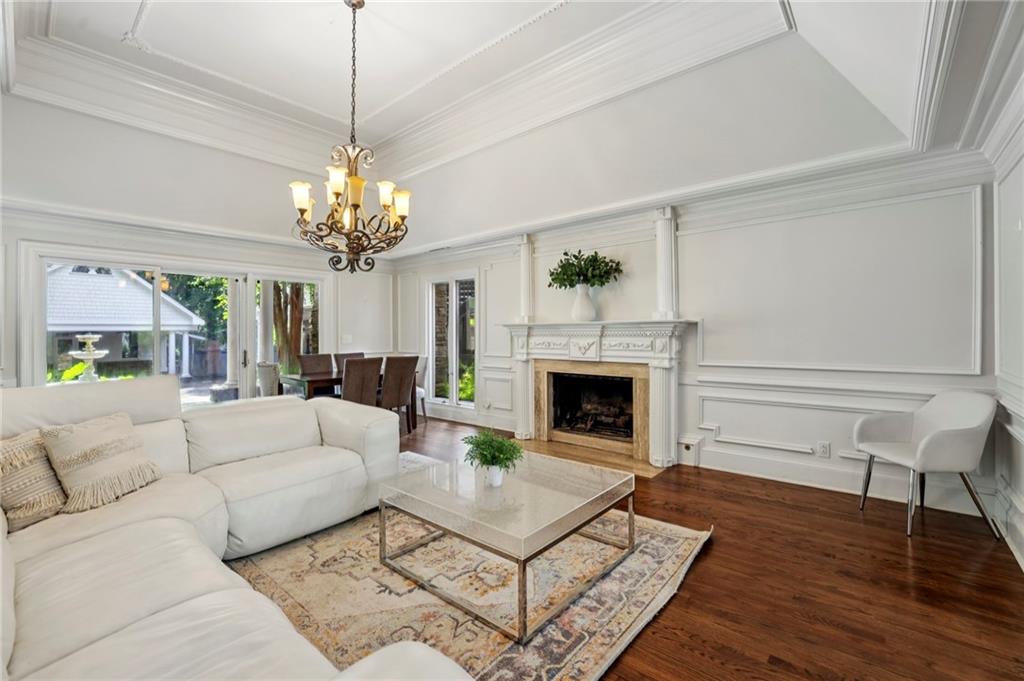 13039 Freemanville Road Alpharetta, GA 30004 - Photo 11 of 62 a living room with furniture a chandelier and a fireplace