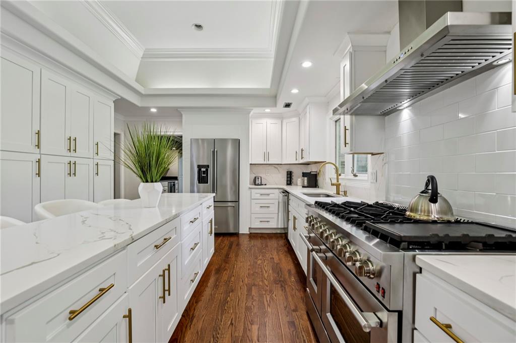 13039 Freemanville Road Alpharetta, GA 30004 - Photo 13 of 62 a kitchen with a stove and a sink