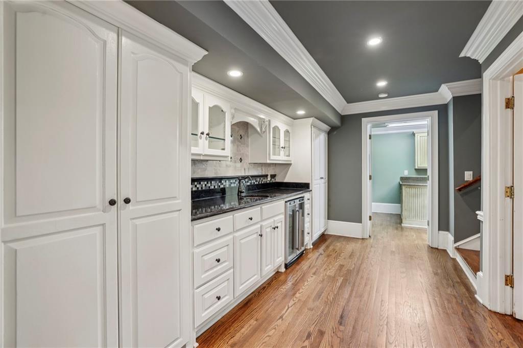 13039 Freemanville Road Alpharetta, GA 30004 - Photo 16 of 62 a large kitchen with a lot of counter space and wooden floor