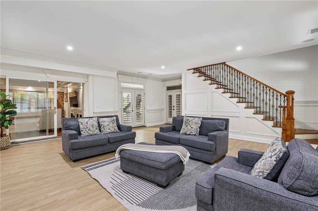 13039 Freemanville Road Alpharetta, GA 30004 - Photo 24 of 62 a living room with furniture and a wooden floor