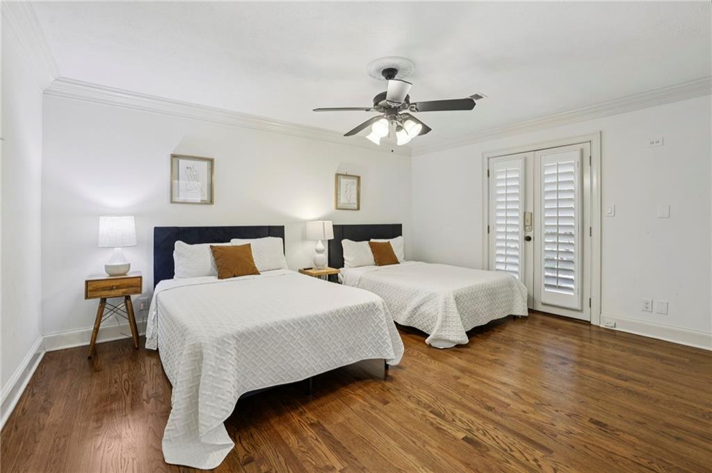 13039 Freemanville Road Alpharetta, GA 30004 - Photo 25 of 62 a bedroom with two beds and a chandelier