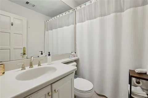 a bathroom with a tub a sink a mirror and a shower