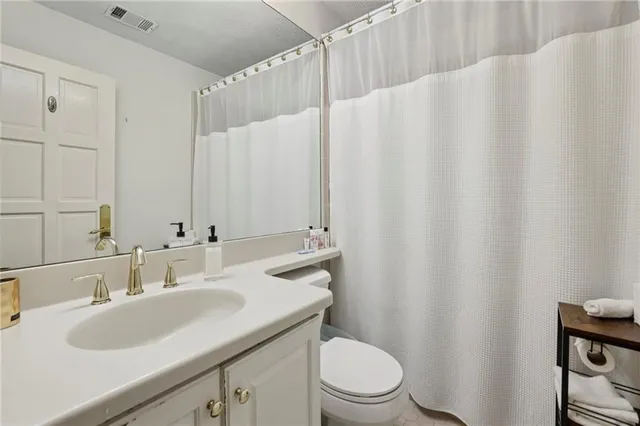 a bathroom with a tub a sink a mirror and a shower