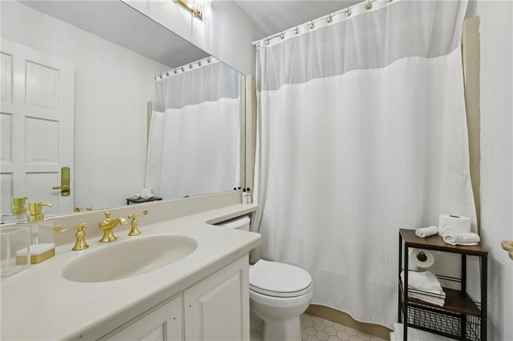 13039 Freemanville Road Alpharetta, GA 30004 - Photo 28 of 62 a bathroom with a sink toilet and shower