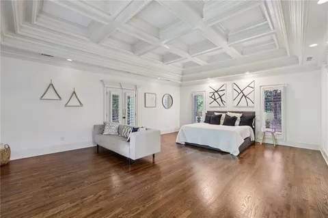a kitchen with granite countertop a sink cabinets and wooden floor