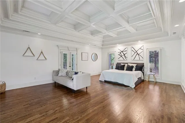 a kitchen with granite countertop a sink cabinets and wooden floor