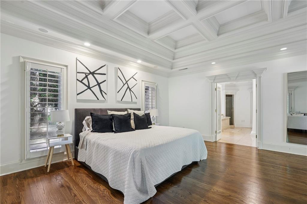 13039 Freemanville Road Alpharetta, GA 30004 - Photo 30 of 62 a bedroom with a large bed and wooden floor