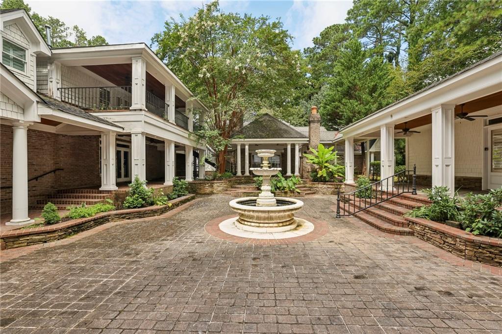 13039 Freemanville Road Alpharetta, GA 30004 - Photo 3 of 62 a view of a white house with large windows and a table and chairs