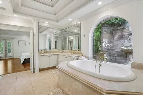 a bedroom with a bed window and couch