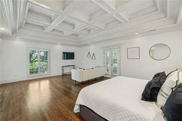 a bedroom with a large bed and a rug