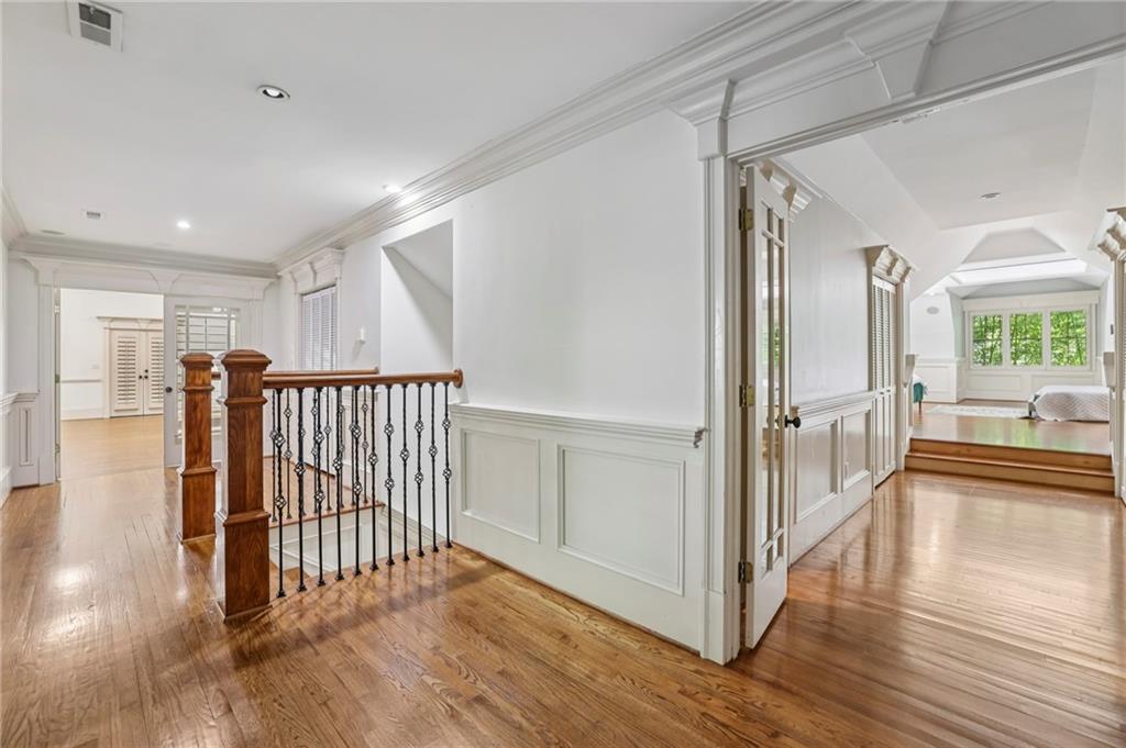 13039 Freemanville Road Alpharetta, GA 30004 - Photo 34 of 62 a view of a hallway view with wooden floor and staircase