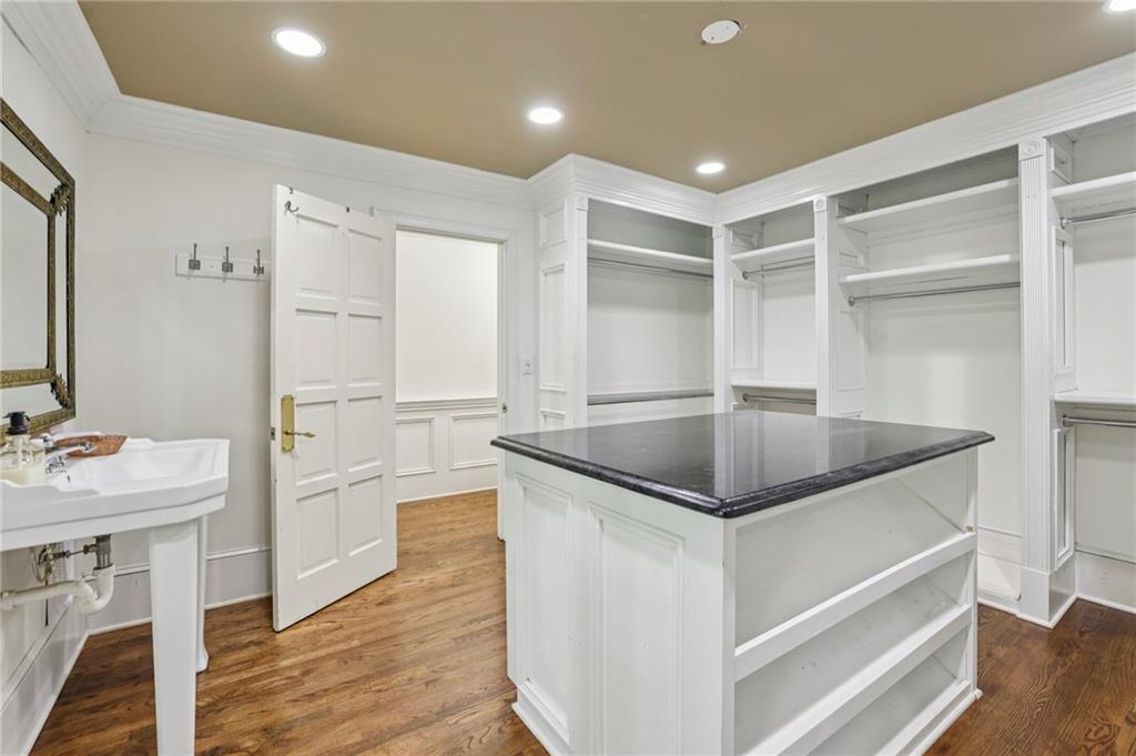 13039 Freemanville Road Alpharetta, GA 30004 - Photo 35 of 62 a kitchen with granite countertop a sink cabinets and wooden floor