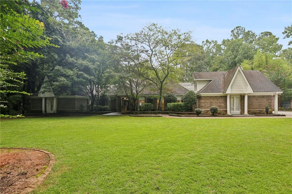 13039 Freemanville Road Alpharetta, GA 30004 - Photo 4 of 62 a front view of a house with a garden