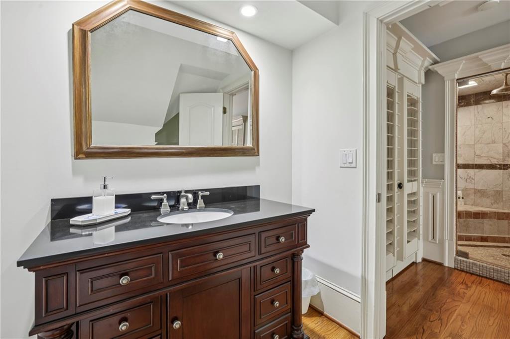 13039 Freemanville Road Alpharetta, GA 30004 - Photo 42 of 62 a bathroom with a sink a mirror and a vanity