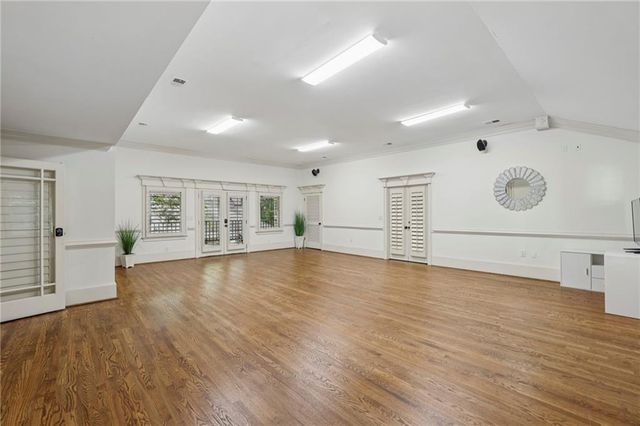 a kitchen with stainless steel appliances kitchen island granite countertop a table and chairs in it