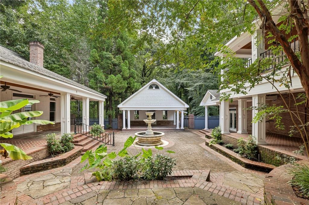 13039 Freemanville Road Alpharetta, GA 30004 - Photo 50 of 62 a front view of a house with a yard table and chairs
