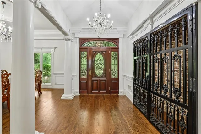 a view of a dining room with furniture wooden floor and chandelier