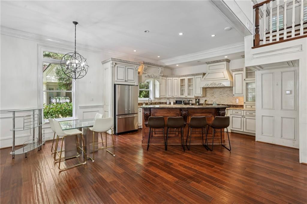 13039 Freemanville Road Alpharetta, GA 30004 - Photo 54 of 62 a kitchen with stainless steel appliances kitchen island granite countertop a table and chairs in it